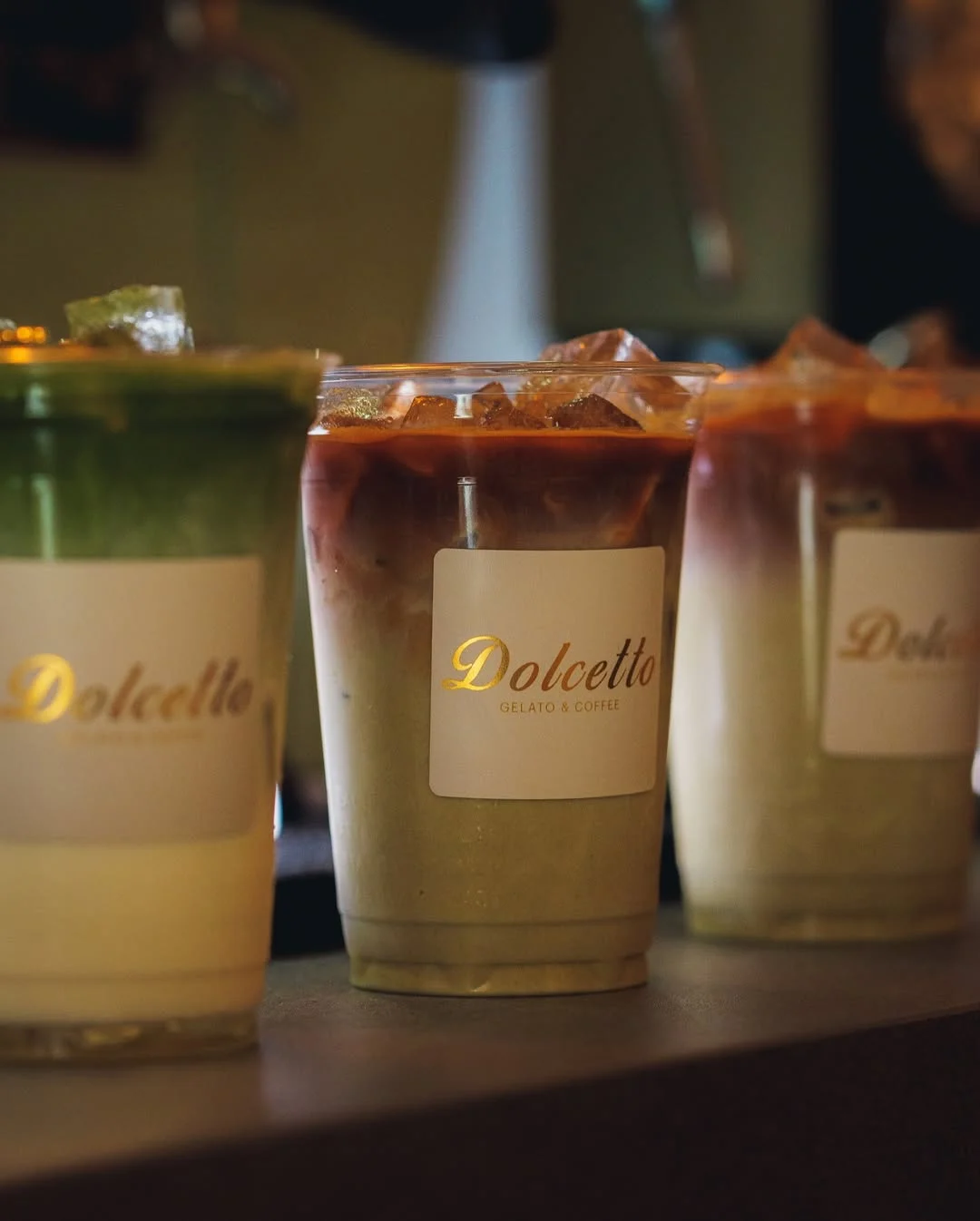 Artisan iced coffee and matcha from Dolcetto in warm light